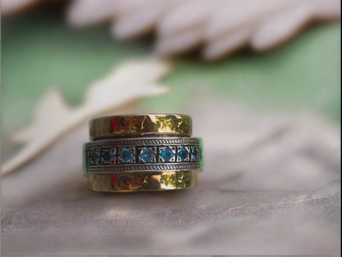 sd designs 14k and sterling silver spinner ring with blue topaz