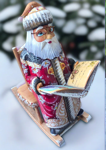 carved russian santa- santa in rocking chair reading a book