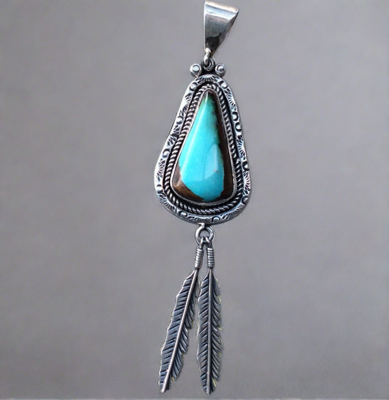 hand crafted native american turquoise pendant with feather accent